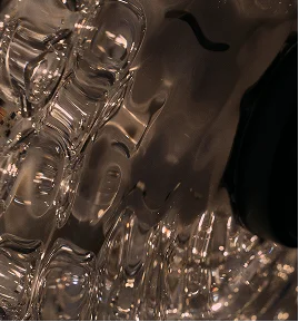 Crystal glassware with water being poured, showing reflective surfaces and elegant tableware in soft lighting - Instagram in Montreal, QC
