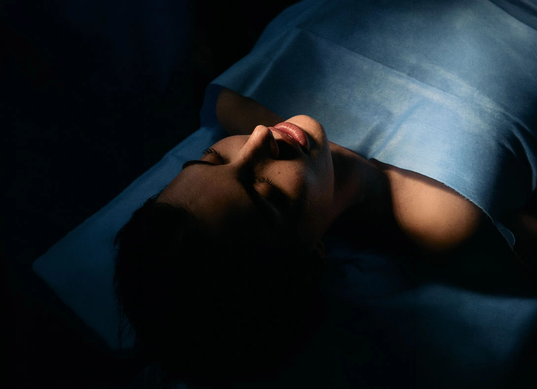 Person lying down with surgical drape over face before rhinoplasty nose surgery procedure - Rhinoplasty in Montreal, QC