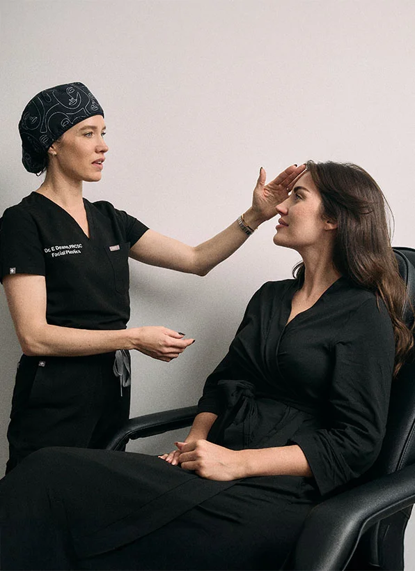 Doctor Emily Deane consulting with female patient about dermal filler treatment in clinical setting - in Montreal, QC