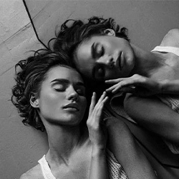 Two women with sculpted cheekbones in dramatic black and white portrait showcasing facial contours and bone structure - Facial fat transfer in Montreal, QC