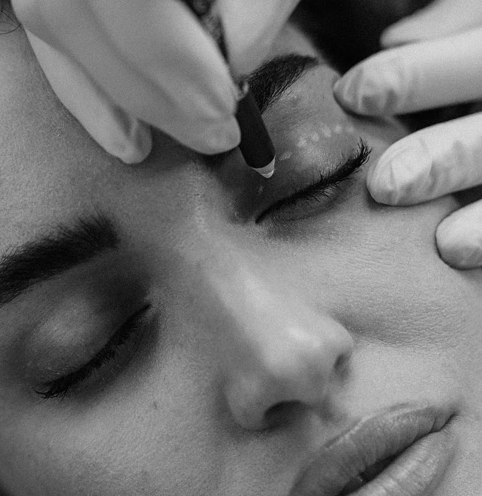 Woman receiving professional eyebrow shaping and grooming treatment at beauty salon - right eyes in Montreal, QC