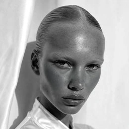 Close-up portrait of model with sleek hair and lifted eyebrows showing defined facial contours in black and white - lip lift in Montreal, QC