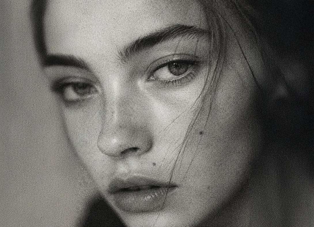 Close-up black and white portrait of young woman's face showing natural facial features and nose profile - Teen Rhinoplasty in Montreal, QC
