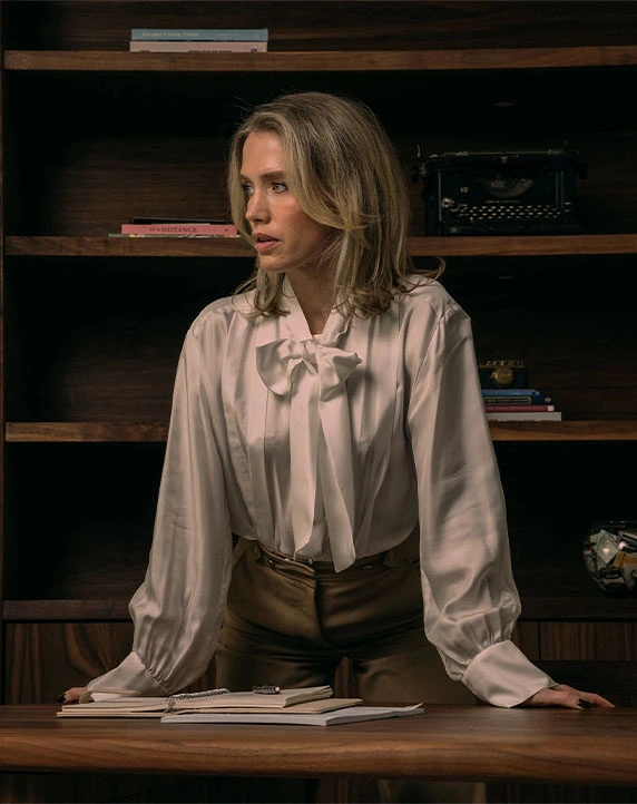 Doctor Emily Deane MD in cream blouse at wooden desk with bookshelves in professional office setting - in Montreal, QC
